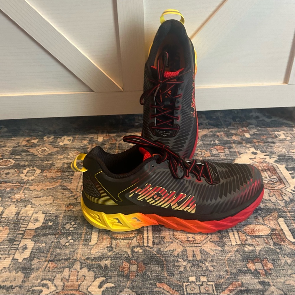 Hoka Black and Red Athletic Shoes with Yellow Accents / Hoka One One Arahi.